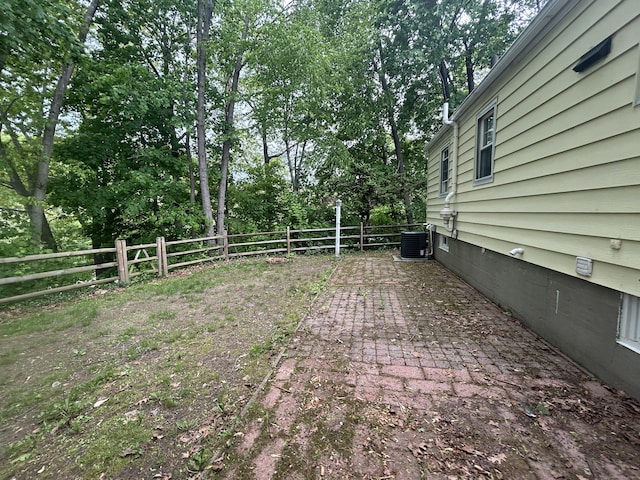138 Radnor Ave, Naugatuck, CT 06770 - fenced backyard with central AC, a patio area, and view of scattered trees