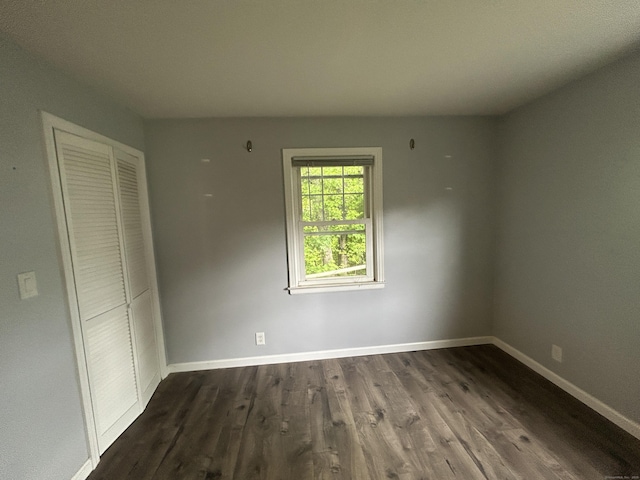 138 Radnor Ave, Naugatuck, CT 06770 - unfurnished bedroom with a closet, baseboards, and dark wood-type flooring