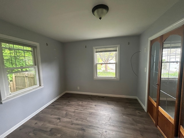 138 Radnor Ave, Naugatuck, CT 06770 - spare room with healthy amount of natural light, dark wood-style floors, and baseboards