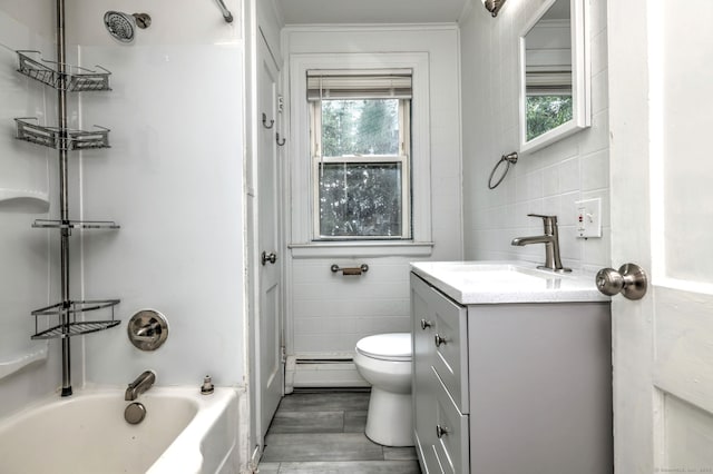 9 Woodland St, Vernon, CT 06066 - full bathroom with a baseboard heating unit, tile walls, vanity, bathtub / shower combination, and wood finished floors