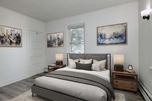 9 Woodland St, Vernon, CT 06066 - bedroom featuring baseboard heating, wood finished floors, and ornamental molding