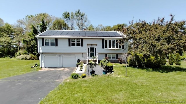 71 Sentinel Hill Rd, North Haven, CT 06473 - raised ranch with an attached garage, driveway, a front yard, and solar panels