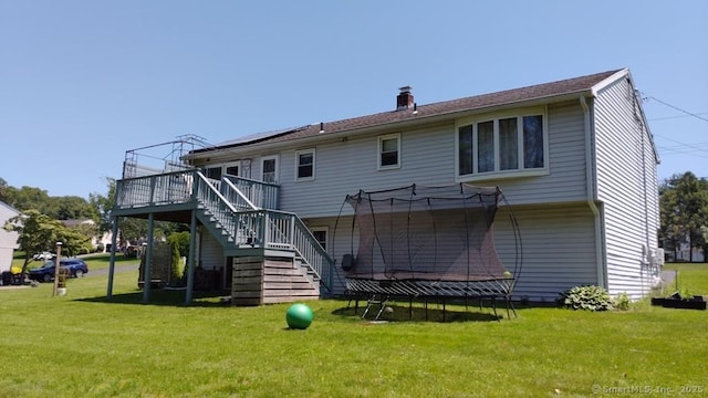 71 Sentinel Hill Rd, North Haven, CT 06473 - rear view of property with a trampoline, stairs, a deck, and a lawn