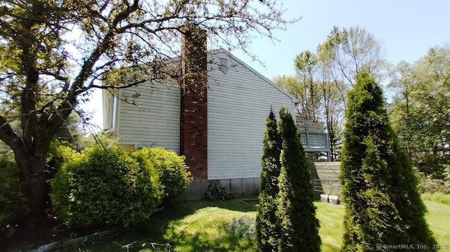 71 Sentinel Hill Rd, North Haven, CT 06473 - view of side of property with a chimney and a yard