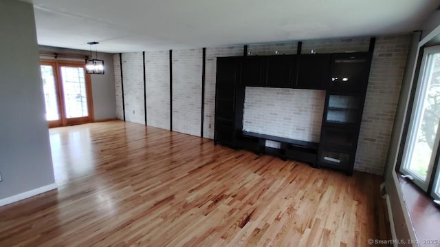 71 Sentinel Hill Rd, North Haven, CT 06473 - unfurnished living room with wood finished floors and a chandelier