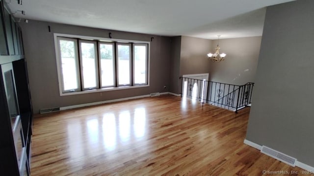 71 Sentinel Hill Rd, North Haven, CT 06473 - spare room with a chandelier and light wood-style floors
