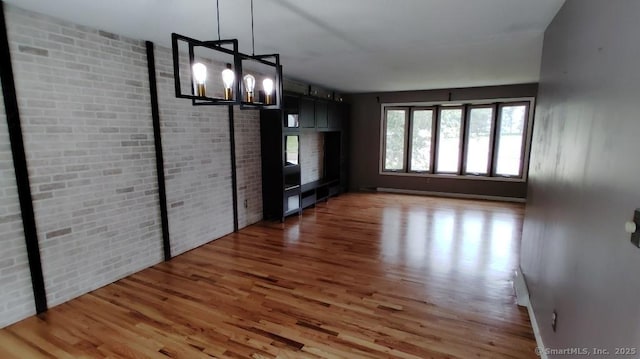 71 Sentinel Hill Rd, North Haven, CT 06473 - unfurnished living room with wood finished floors and a chandelier
