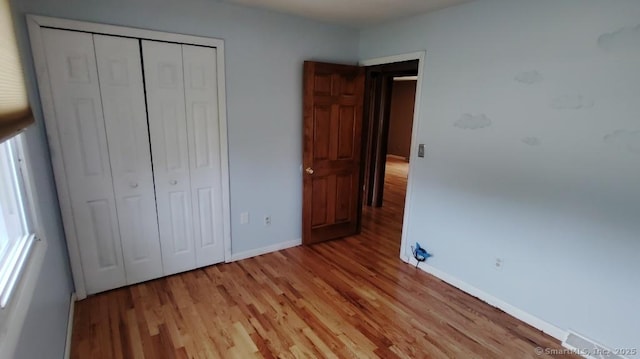 71 Sentinel Hill Rd, North Haven, CT 06473 - unfurnished bedroom featuring light wood finished floors and a closet