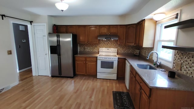 71 Sentinel Hill Rd, North Haven, CT 06473 - kitchen with white appliances, under cabinet range hood, light wood finished floors, decorative backsplash, and brown cabinets