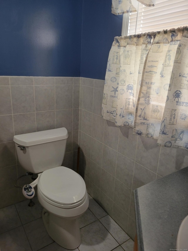 26 King St, Shelton, CT 06484 - bathroom with tile patterned floors, toilet, tile walls, and wainscoting