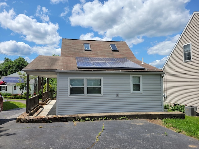 26 King St, Shelton, CT 06484 - rear view of property with central AC, roof mounted solar panels, and a shingled roof