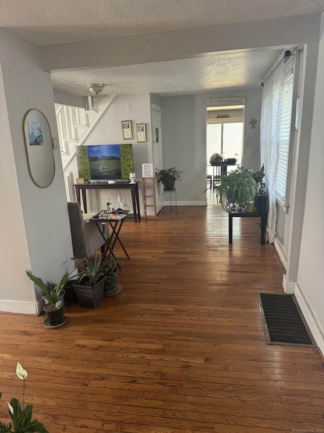 52 Platt St, Bridgeport, CT 06606 - living room featuring hardwood / wood-style flooring, stairway, baseboards, and a textured ceiling