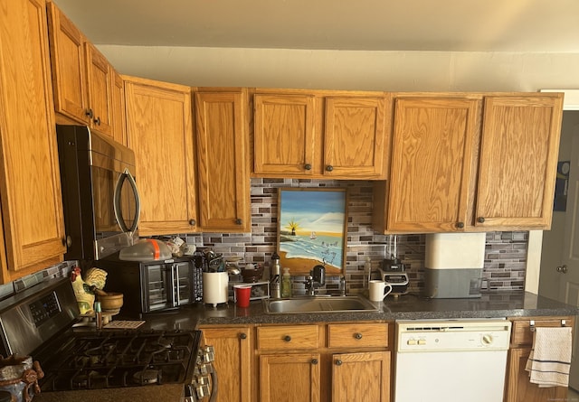 52 Platt St, Bridgeport, CT 06606 - kitchen with stainless steel appliances, a sink, tasteful backsplash, and dark countertops