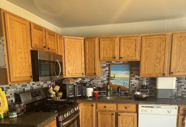 52 Platt St, Bridgeport, CT 06606 - kitchen with stainless steel appliances, tasteful backsplash, a sink, and dark countertops