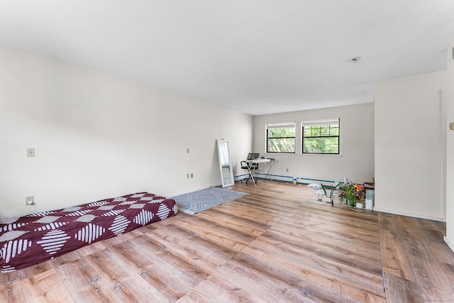 3 Clemens Ct Unit 3, Rocky Hill, CT 06067 - unfurnished room featuring wood finished floors, a pendent fire sprinkler, a baseboard radiator, and baseboards