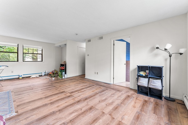 3 Clemens Ct Unit 3, Rocky Hill, CT 06067 - unfurnished living room featuring wood finished floors, a baseboard radiator, and baseboards