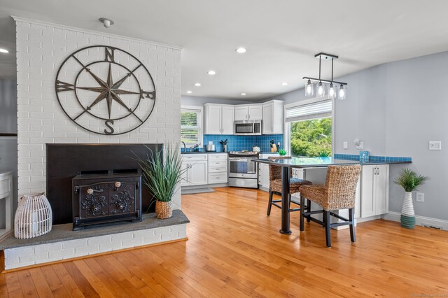 49 Economy Dr, Westbrook, CT 06498 - kitchen featuring stainless steel appliances, light wood-style floors, recessed lighting, white cabinetry, and backsplash