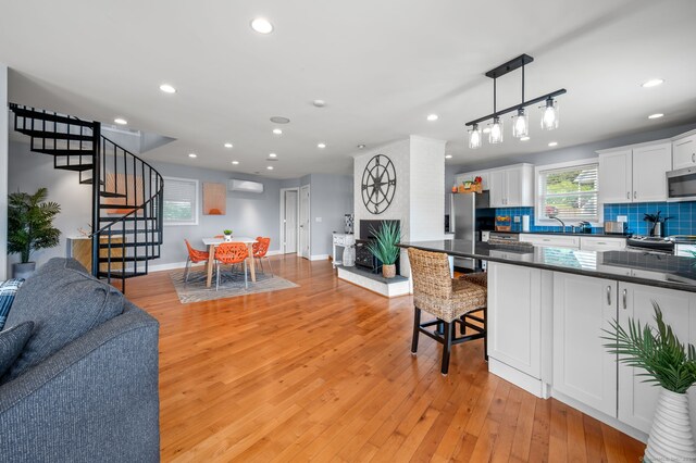 49 Economy Dr, Westbrook, CT 06498 - kitchen featuring stainless steel appliances, open floor plan, dark countertops, backsplash, and recessed lighting