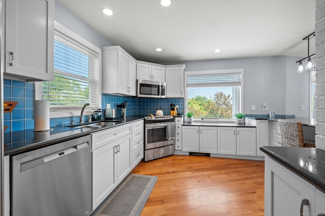 49 Economy Dr, Westbrook, CT 06498 - kitchen with appliances with stainless steel finishes, a sink, dark countertops, backsplash, and recessed lighting