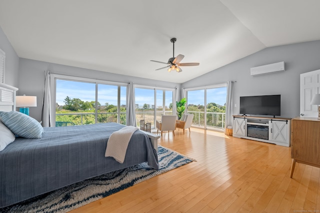 49 Economy Dr, Westbrook, CT 06498 - bedroom featuring a wall unit AC, access to exterior, lofted ceiling, light wood-type flooring, and ceiling fan