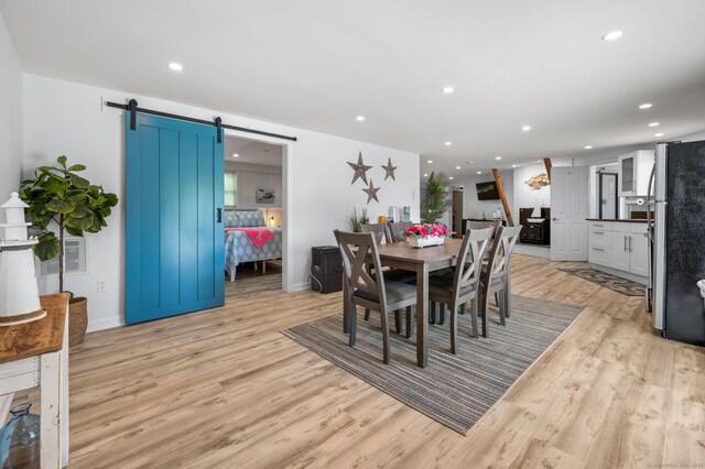 49 Economy Dr, Westbrook, CT 06498 - dining area featuring a barn door, light wood-type flooring, recessed lighting, and baseboards