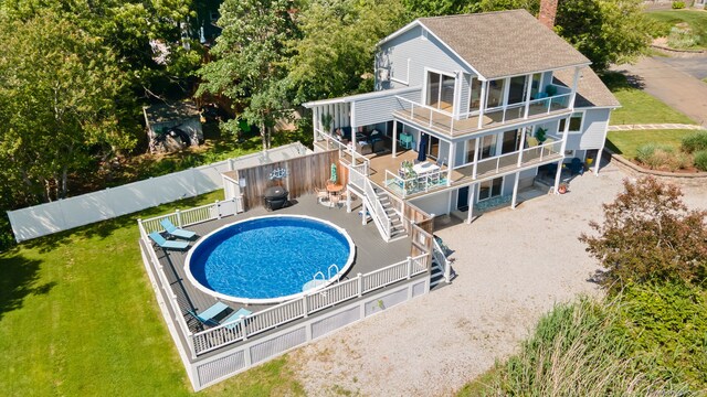 49 Economy Dr, Westbrook, CT 06498 - back of house featuring a balcony, a shingled roof, a chimney, and stairs