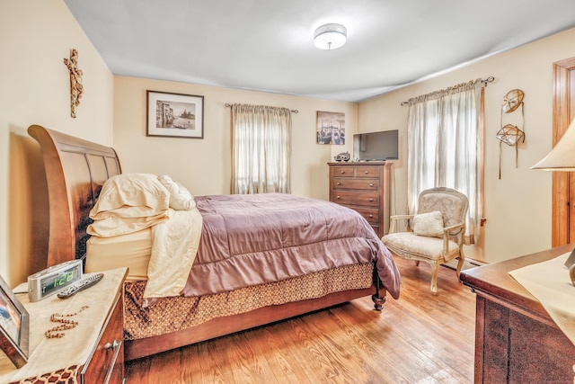 103 Mount Pleasant St, Derby, CT 06418 - bedroom with multiple windows, wood finished floors, and a baseboard radiator
