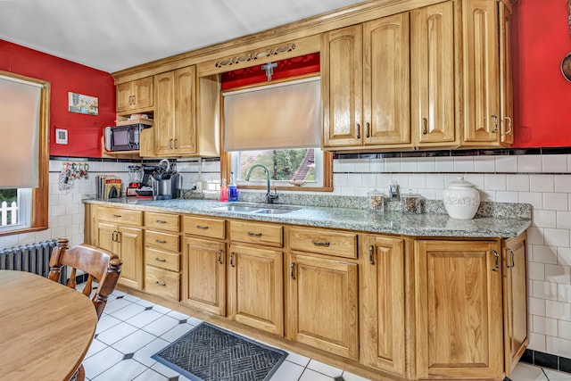103 Mount Pleasant St, Derby, CT 06418 - kitchen with black microwave, tile walls, healthy amount of natural light, light tile patterned floors, and a wainscoted wall
