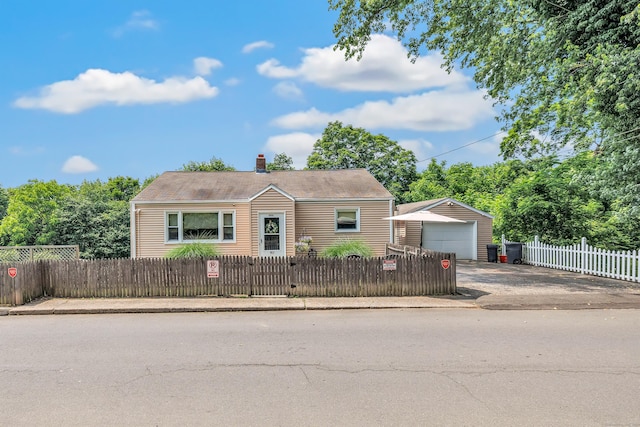 103 Mount Pleasant St, Derby, CT 06418 - view of front of home featuring a detached garage, an outdoor structure, driveway, a fenced front yard, and a chimney