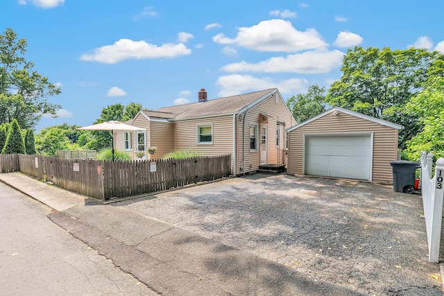 103 Mount Pleasant St, Derby, CT 06418 - view of front of house featuring asphalt driveway, an outdoor structure, a fenced front yard, and a garage