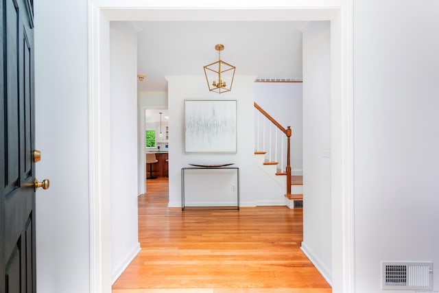 17 Joanne Ln, Weston, CT 06883 - entryway featuring a chandelier, light wood-style flooring, and stairs