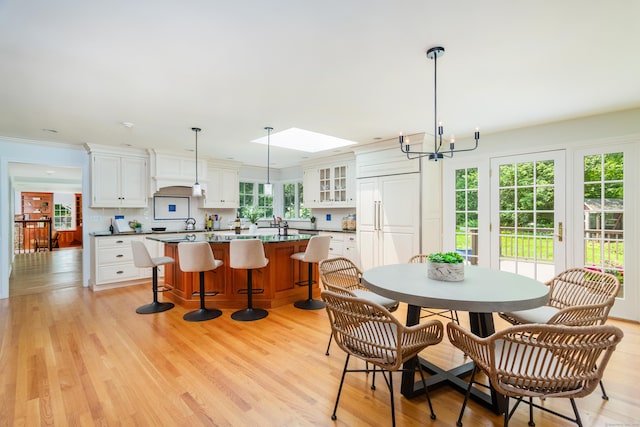 17 Joanne Ln, Weston, CT 06883 - dining space featuring a chandelier, light wood-style flooring, and a skylight