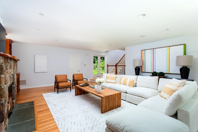 17 Joanne Ln, Weston, CT 06883 - living area with light wood-style flooring, stairs, baseboards, a stone fireplace, and recessed lighting