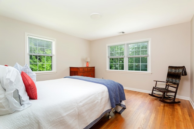 17 Joanne Ln, Weston, CT 06883 - bedroom with multiple windows, wood finished floors, and baseboards