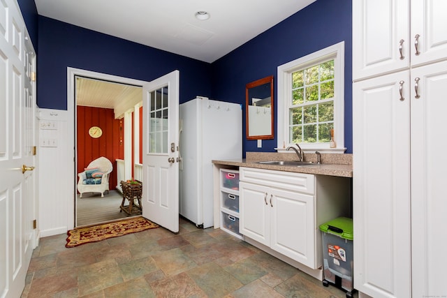 17 Joanne Ln, Weston, CT 06883 - kitchen with a sink, freestanding refrigerator, stone finish floors, and white cabinets