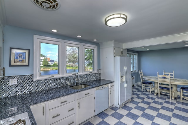 660 Ocean Ave, West Haven, CT 06516 - kitchen with white appliances, light floors, plenty of natural light, white cabinetry, and recessed lighting