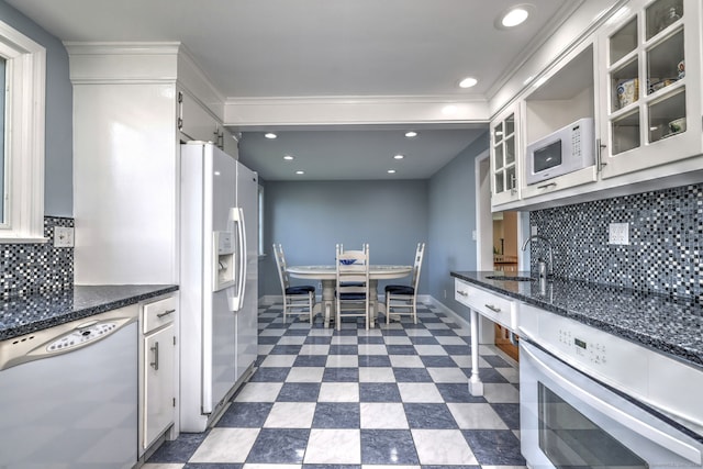 660 Ocean Ave, West Haven, CT 06516 - kitchen with white appliances, white cabinetry, backsplash, glass insert cabinets, and recessed lighting