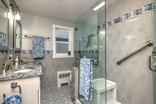 660 Ocean Ave, West Haven, CT 06516 - bathroom with radiator heating unit, tile walls, a stall shower, and double vanity