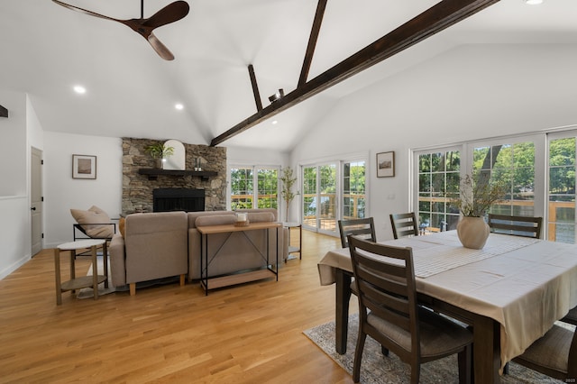 15 Fedus Dr, East Haddam, CT 06415 - dining room featuring a stone fireplace, ceiling fan, beamed ceiling, light wood-style flooring, and high vaulted ceiling