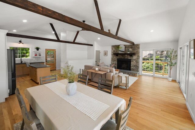 15 Fedus Dr, East Haddam, CT 06415 - dining space with light wood-style flooring, beamed ceiling, healthy amount of natural light, recessed lighting, and a stone fireplace