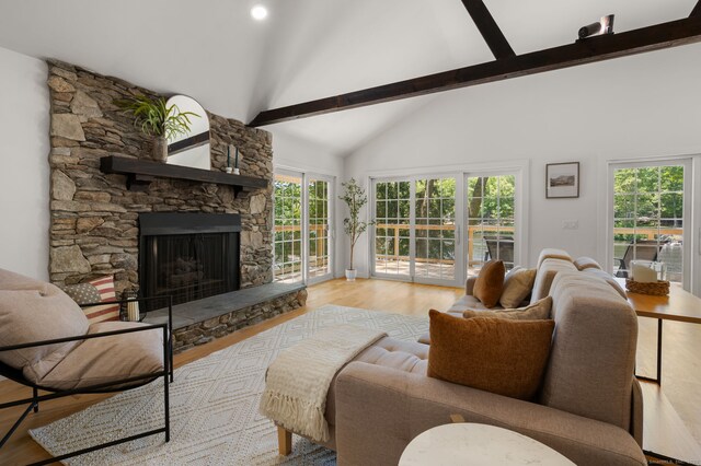 15 Fedus Dr, East Haddam, CT 06415 - living room featuring a stone fireplace, plenty of natural light, high vaulted ceiling, beam ceiling, and wood finished floors
