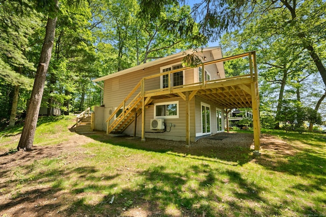 15 Fedus Dr, East Haddam, CT 06415 - back of property featuring stairs, ac unit, a wooden deck, and a lawn