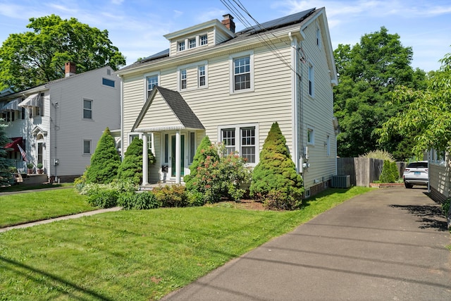 1748 Whitney Ave, Hamden, CT 06517 - traditional style home with cooling unit, a chimney, and asphalt driveway