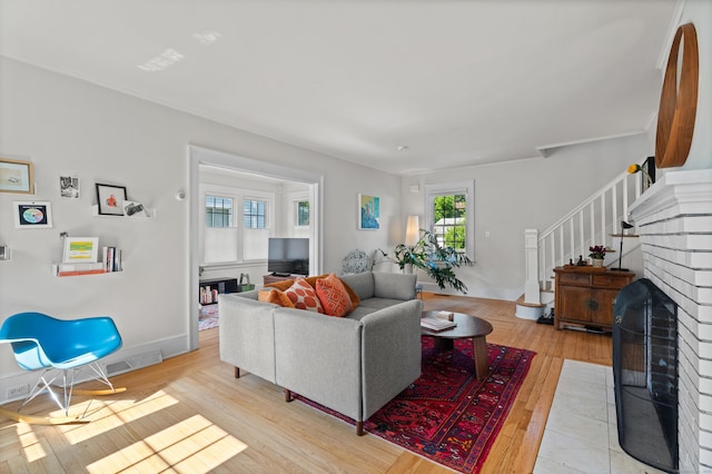 1748 Whitney Ave, Hamden, CT 06517 - living room with light wood-style flooring, stairs, and baseboards