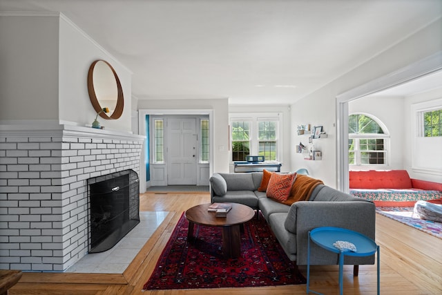 1748 Whitney Ave, Hamden, CT 06517 - living room featuring a brick fireplace and light wood-style flooring