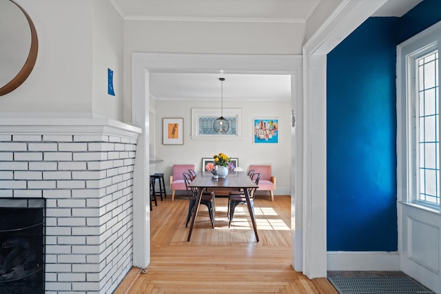 1748 Whitney Ave, Hamden, CT 06517 - dining space featuring a brick fireplace, ornamental molding, and baseboards