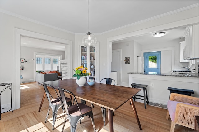 1748 Whitney Ave, Hamden, CT 06517 - dining area featuring crown molding and light wood-style flooring