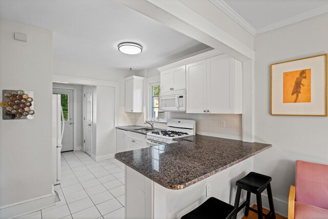 1748 Whitney Ave, Hamden, CT 06517 - kitchen featuring white appliances, baseboards, a sink, decorative backsplash, and crown molding