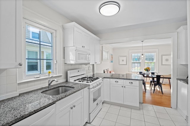 1748 Whitney Ave, Hamden, CT 06517 - kitchen featuring white appliances, a sink, a peninsula, white cabinetry, and light tile patterned floors