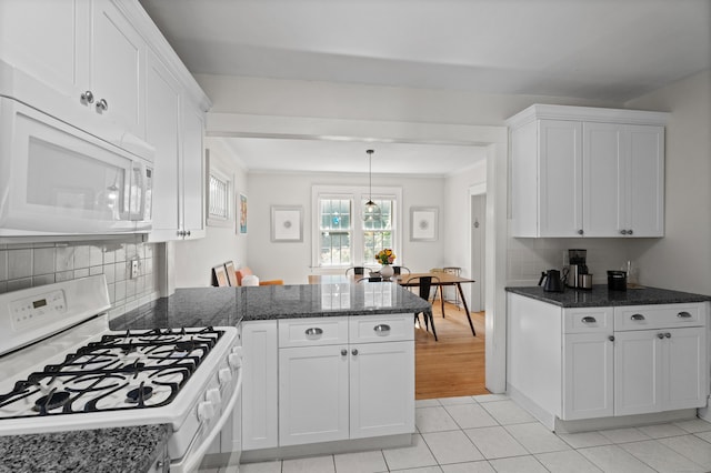 1748 Whitney Ave, Hamden, CT 06517 - kitchen with white appliances, white cabinetry, a peninsula, backsplash, and dark stone countertops